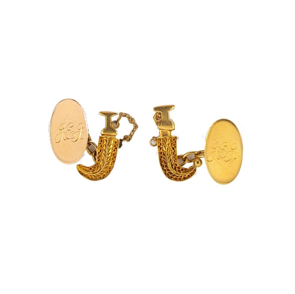 A pair of cufflinks,: A pair of cufflinks, each with an oval panel engraved 'JEJ', approximately 2 x 1.2cm, and a khanjar dagger with filigree sheath, chain connection, unmarked, tested as 18ct gold, weight 10g, Provenance