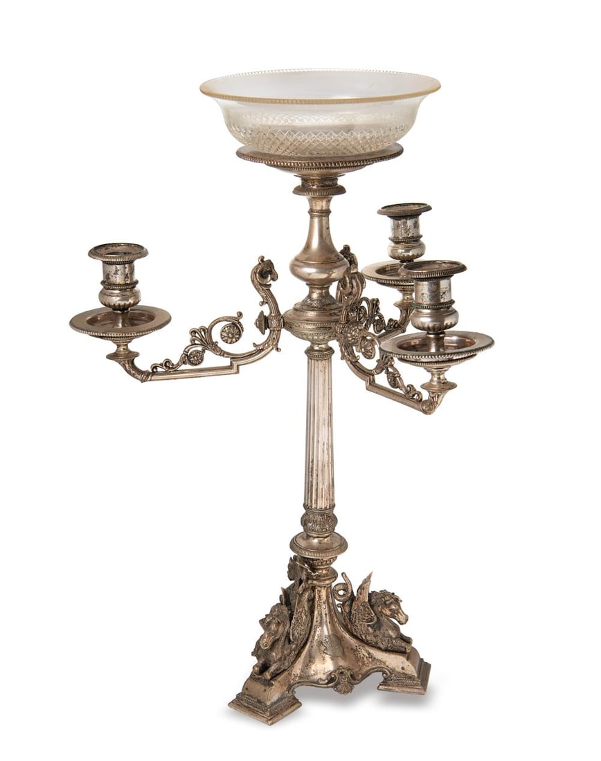 A silver plated three branch candelabra centrepiece,: A silver plated three branch candelabra centrepiece, apparently unmarked, probably late 19th century, triform cast base with three dragons and monograms, tapered fluted column, three decorative branch