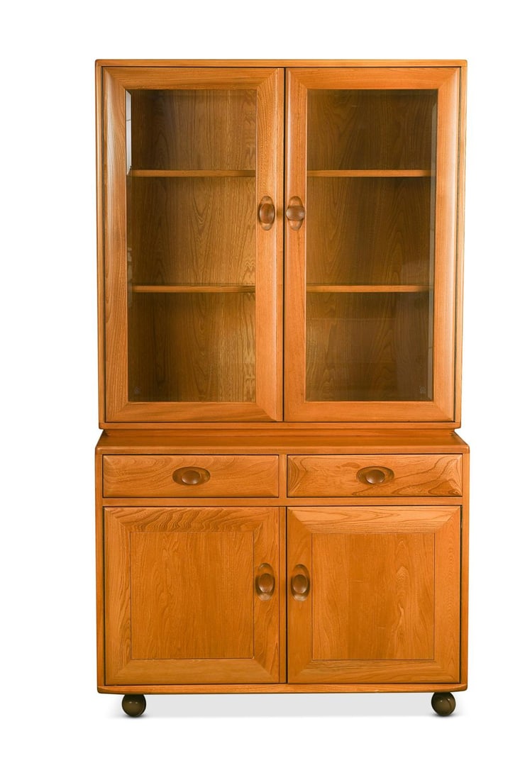 An Ercol 'Windsor' elm bookcase,: An Ercol 'Windsor' elm bookcase, the glazed two-door top section above a two drawer and two cupboard base 162 x 91 x 43cm