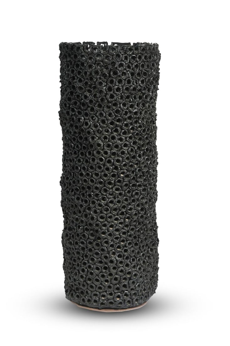 § Gilles Caffier, a large pierced vase,: § Gilles Caffier, a large pierced vase, of organic cylindrical form, in black gloss glaze, reference VA072BA-GY, impressed marks and dated 2011/2/30 to the underside 57cm tall