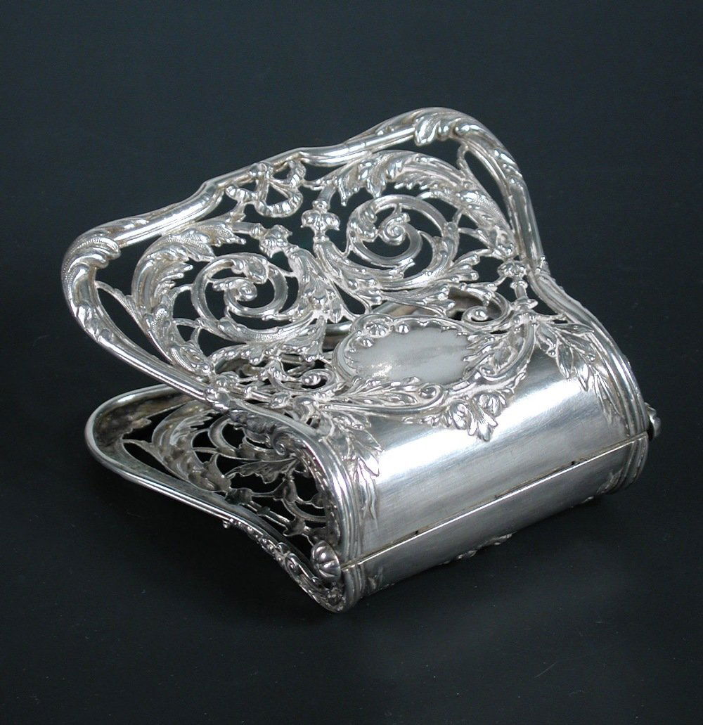 A pair of French silver 'Main Pince' or asparagus serve: A pair of French silver 'Main Pince' or asparagus servers, by Alphonse Debain, Paris 1st standard, circa 1900, the spring loaded blades pierced and embossed with foliate scrolling, 9cm, 3.98oz