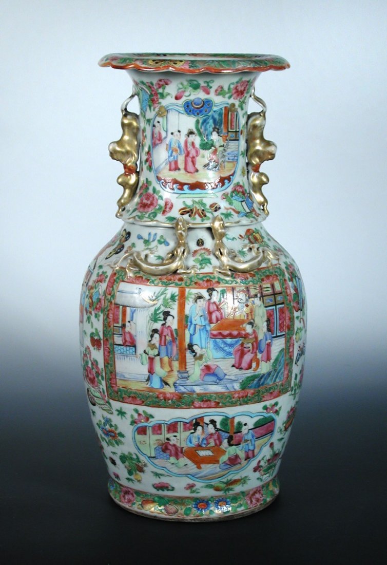 A 19th century Canton vase with wood stand,: A 19th century Canton vase with wood stand, the vase painted with panels of figures on a ground of flowers, fruit and insects, the gilt handles formed of pairs of shishi with iron red brocade balls, 4