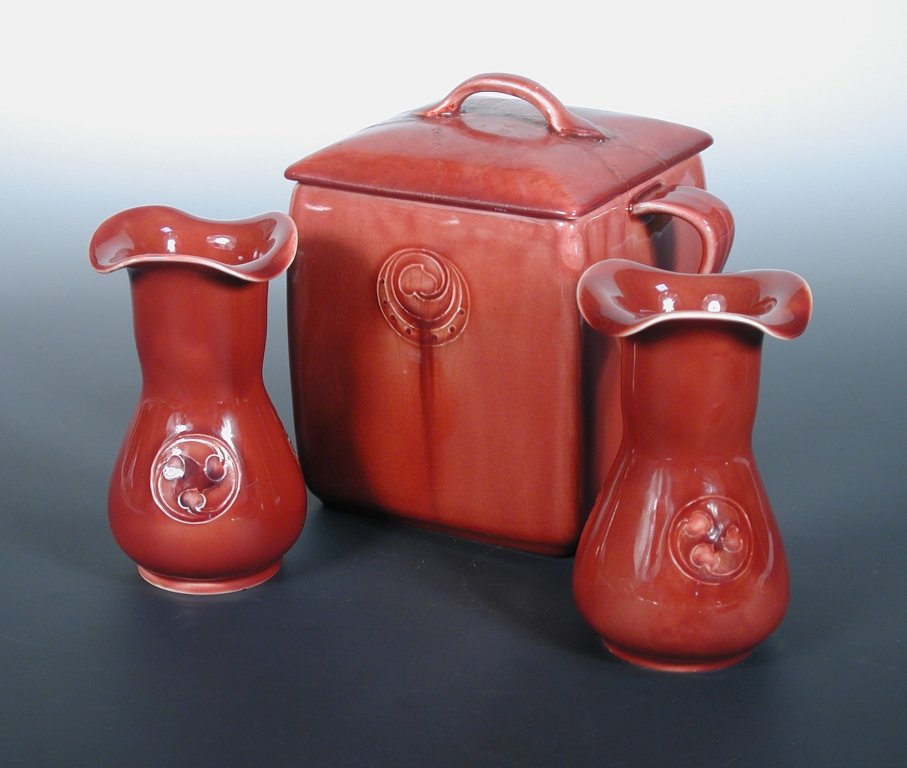 A pair of Moorcroft for Liberty & Co. red Flamminian wa: A pair of Moorcroft for Liberty & Co. red Flamminian ware vases, dated 1912, painted and printed marks, together with similar biscuit box and cover (3)