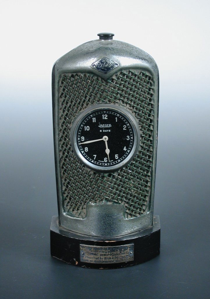 A Jaeger desk clock, modelled as a Riley radiator,: A Jaeger desk clock, modelled as a Riley radiator, presentation plaque to front reads 'Riley Motor Club 12 hour trial, February 1933, Special Trophy Novice Class, Presented by Boon & Porter Ltd., For
