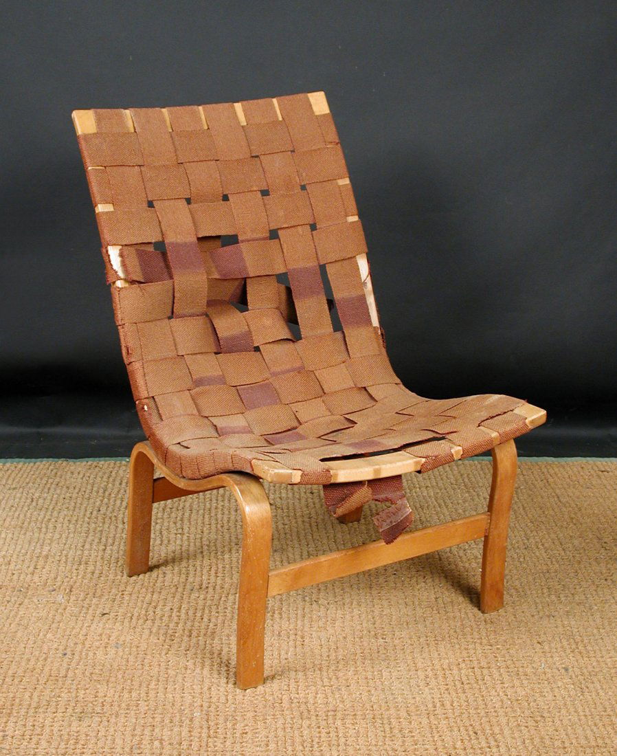 Bruno Mathsson, a laminated beech and canvas webbed 'Ev: Bruno Mathsson, a laminated beech and canvas webbed 'Eva' lounge chair, designed 1934, with paper label to the underside 85cm (33in) Provenance: Private Collection, Cambridge