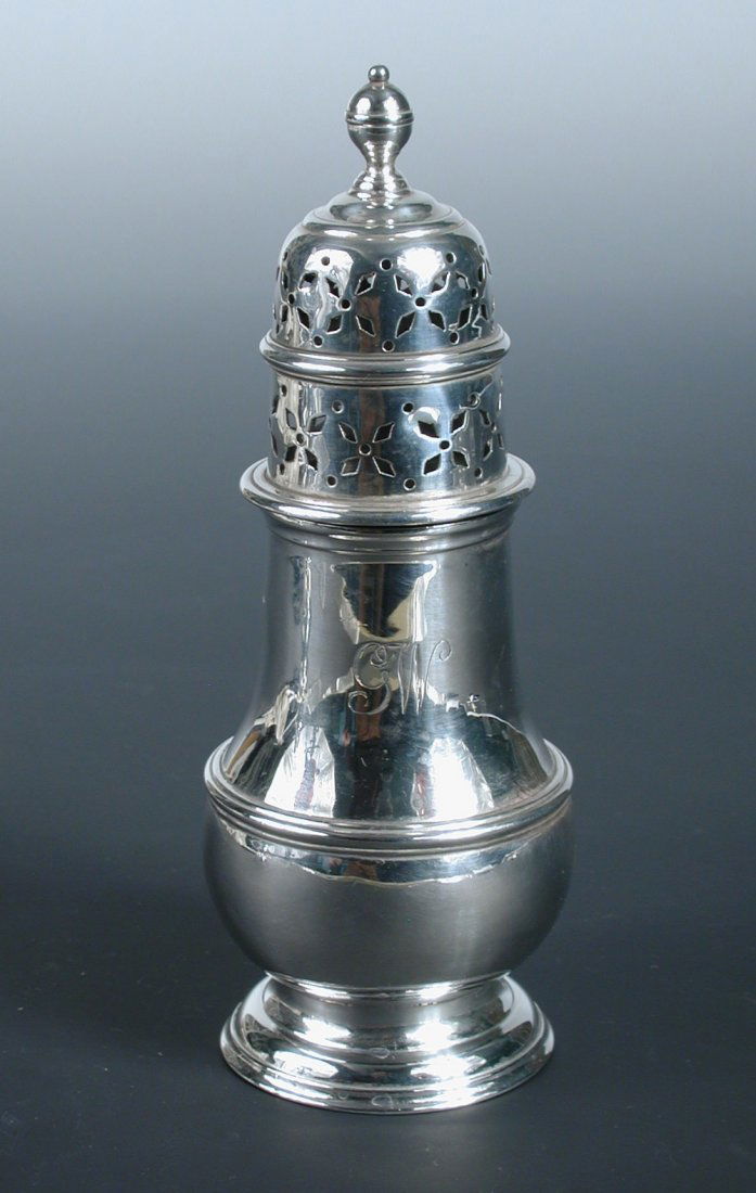 An Edwardian silver caster,: An Edwardian silver caster, by Charles Stuart Harris, London 1901, of plain baluster shape with moulded edge and girdle, the cover decoratively pierced below a ball finial, initialled, 14.5cm, 4.1oz