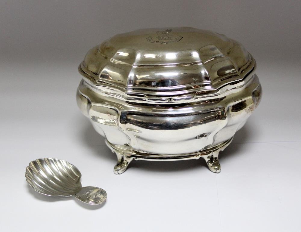 A Victorian silver tea caddy,: A Victorian silver tea caddy, by Charles Stuart Harris, London 1897, of plain lobed bombe shape raised on four everted feet, the hinged cover engraved with a swan crest over 'Hic Eram in Dierum Seculi