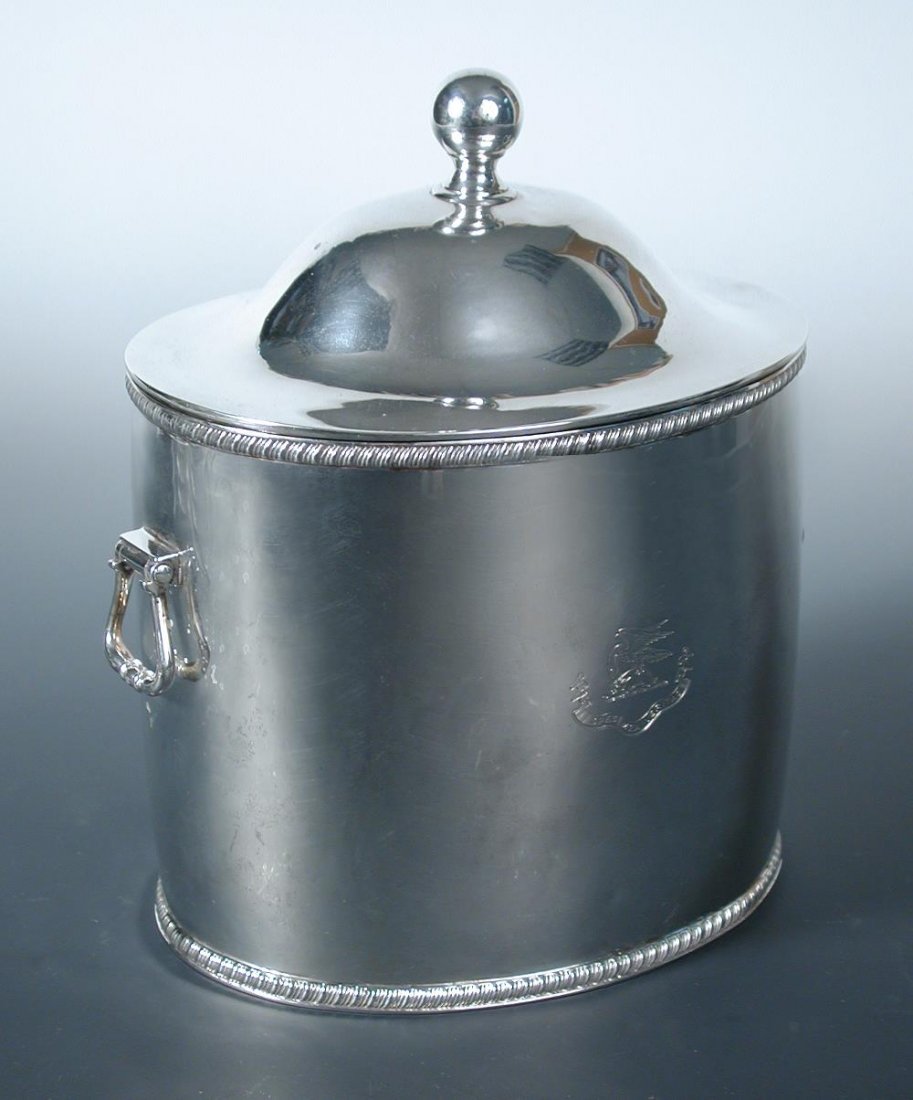 A large Victorian silver biscuit box,: A large Victorian silver biscuit box, by John Marshall Spink, London 1895, of plain of shape between gadrooned edges, the body fitted with two drop loop handles, the detachable low domed cover with ba