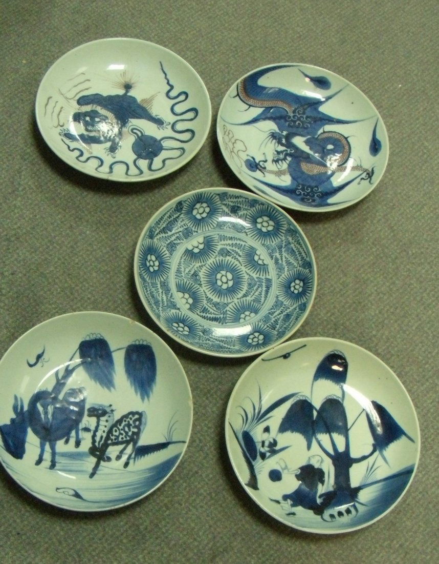 Five 19th century Chinese provincial dishes,: Five 19th century Chinese provincial dishes, three painted in blue with horses, flowers and a figure below a willow tree, the other two in underglaze red and blue with a dragon and a Buddhist lion, 28