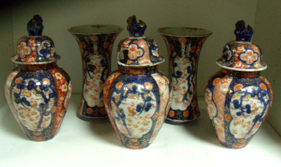 A garniture of five late 19th century Fukugawa vases: A garniture of five late 19th century Fukugawa vases and three covers, each of the two waisted and three ovoid bodies with the ribs painted with alternating panels and with two reserves of pine trees,