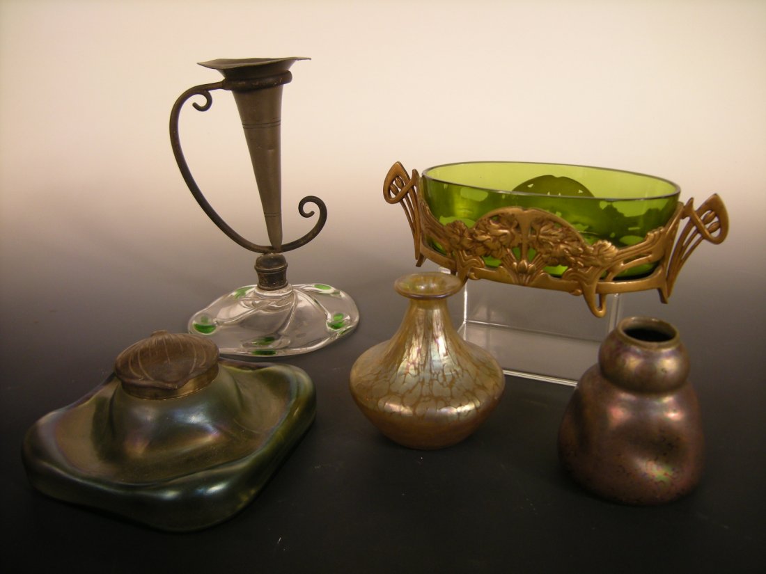 A collection of Art Nouveau glass wares,: A collection of Art Nouveau glass wares, comprising: a gilt metal framed green glass bowl; a compressed form green glass inkwell with hinged brass cover, a stem vase with Powell glass base, a Tiffany 