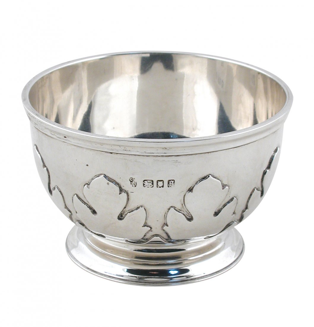 A small 1920's silver bowl,: A small 1920's silver bowl, by Charles Stuart Harris, London 1922, of heavy gauge plain circular form with moulded edge and foliate cut card decoration to the lower body, 10cm diameter, inscribed to t