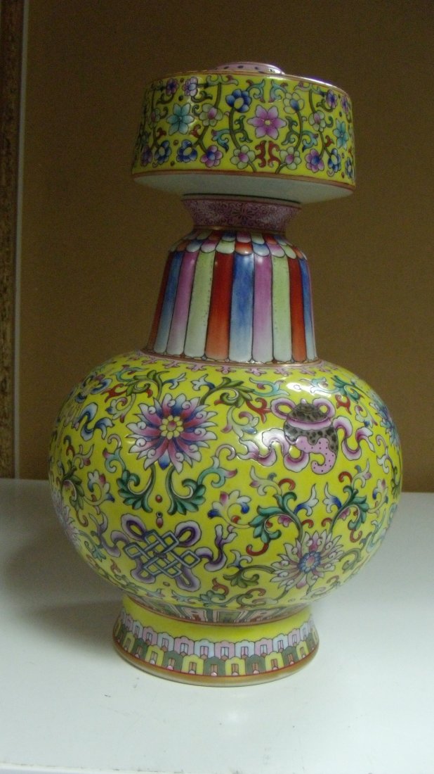 A Jiaqing style yellow ground benba vase: A Jiaqing style yellow ground benba vase painted with scrolling flowers and Buddhist objects, the baluster body with removable bulbous top of cylindrical shape tapering upwards to flat shoulders and a