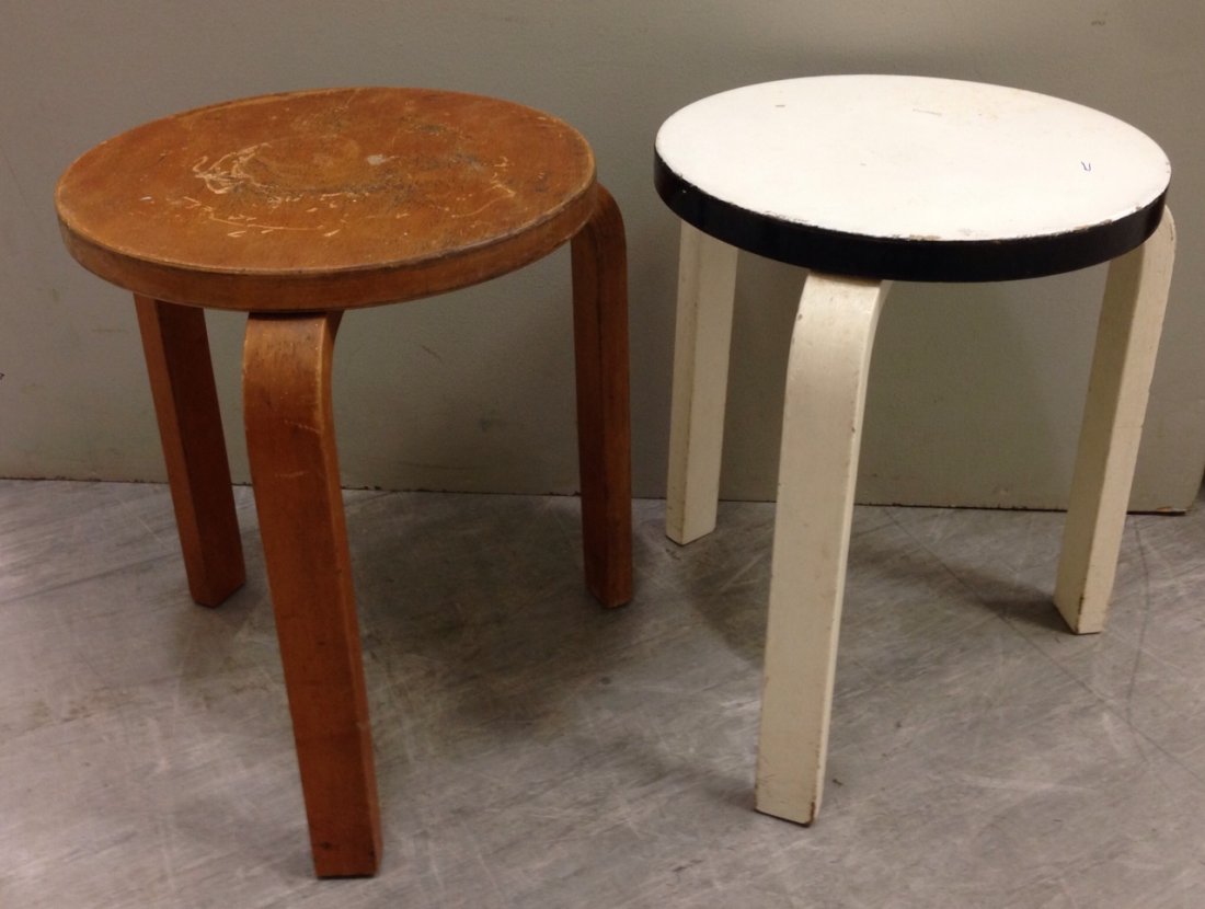 Alvar Aalto for Finmar, two bent plywood model 60: Alvar Aalto for Finmar, two bent plywood model 60 stools, one with laminated plywood finish, the other painted in black and white, Finmar labels and Bowman Brothers label to the painted example (2) 44