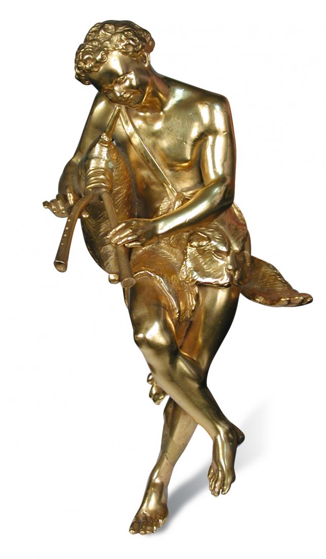 A late 19th/early 20th century ormolu classical mount: A late 19th/early 20th century ormolu classical mount of a pipe player, he wears a lion skin loin cloth as he blows into the fur covered bag bellows of his pipes 33cm (13in)
