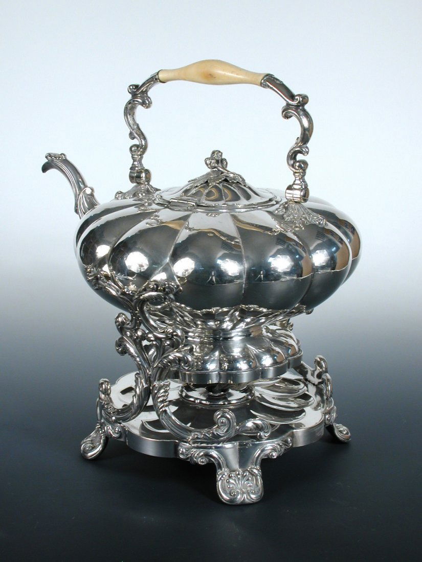 A large early 19th century Old Sheffield plate tea: A large early 19th century Old Sheffield plate tea kettle on stand, the kettle of melon shape with hinged bail handle and bud finial to the cover, the multifoil base raised on four scrolled anthemion