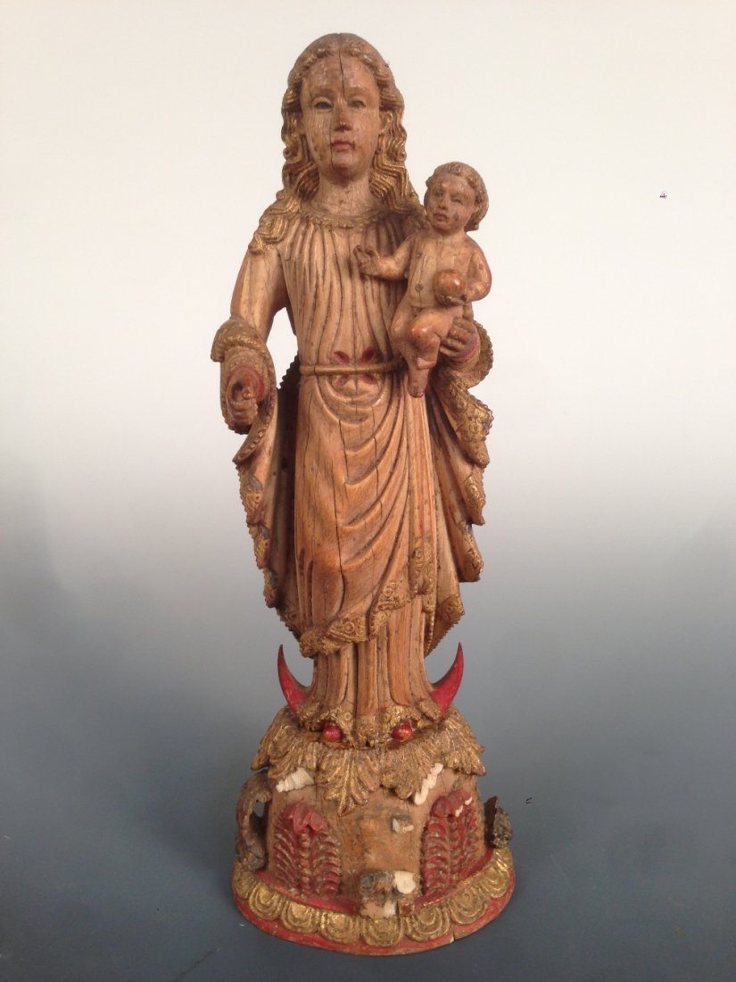 A 17th century Goan ivory Madonna and Child,: A 17th century Goan ivory Madonna and Child, he sits naked in her left hand holding an orb, her robes with gilt lace edging, she stands on a red crescent, the plinth with red, blue and gilt leaves, 21
