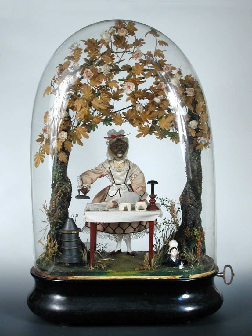 An ironing monkey musical automaton, by Phalibois,: An ironing monkey musical automaton, by Phalibois, circa 1880, the key-wind motor for monkey automaton, with painted papier-mâché head, leather jaw and painted teeth, moving eyes, dressed as a parlo