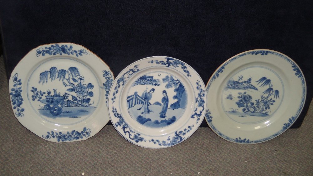 A Transitional and two later blue and white plates,: A Transitional and two later blue and white plates, the first painted with two ladies standing by a fence, 21cm (8.25 in) diameter, the octagonal plate with vases on a rock below a willow tree, 22.5cm