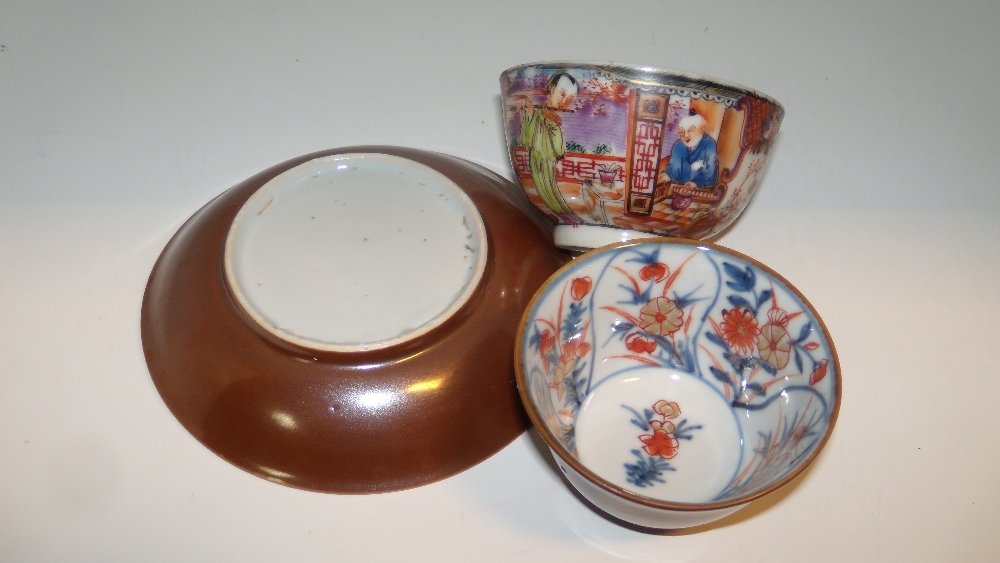 An 18th century Batavian ware tea bowl and saucer and: An 18th century Batavian ware tea bowl and saucer and another tea bowl, the interiors of the first painted with alternating sprays of Imari palette flowers, the reverses brown, the second tea bowl pai