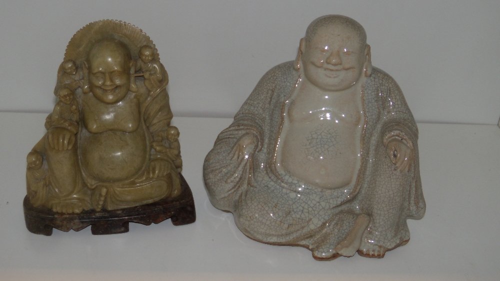 A crackleware and a soapstone figure of Budai,: A crackleware and a soapstone figure of Budai, the bare chested monk seated with his bag of good things, 16.5cm (6.5 in) high, the green soapstone figure backed by a mandala, one of the five small fig