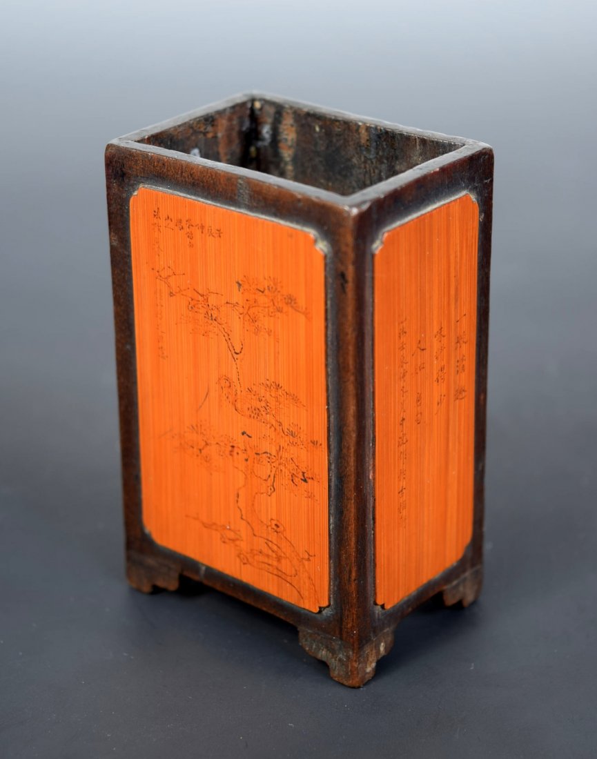 A bamboo brush pot, possibly 17th/18th century,: A bamboo brush pot, possibly 17th/18th century, blond panels raised above the dark wood cut away from the corners of the rectangular sectioned body and incised with script about a pine tree, Buddhist 