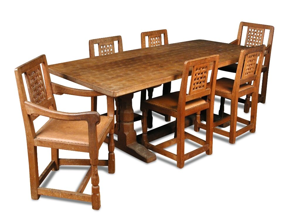 A Robert 'Mouseman' Thompson oak table and six chairs,: A Robert 'Mouseman' Thompson oak table and six chairs, the adzed rectangular top on a shaped twin column base accompanied by six lattice back chairs (7) 72 x 198 x 86cm (28 x 77 x 34in)