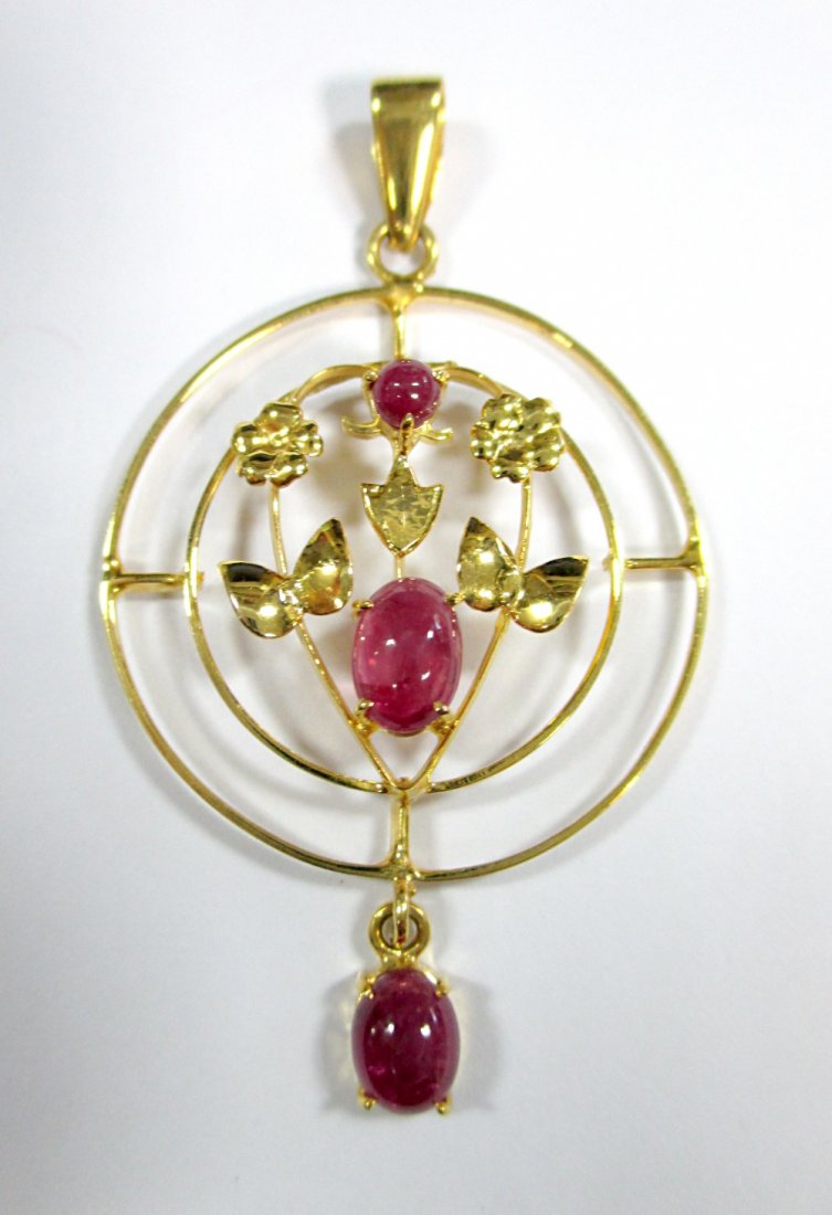 An Edwardian style ruby pendant,: An Edwardian style ruby pendant, designed as concentric hoops with a floral motif in the centre set with a round and an oval cabochon ruby, and suspending a further similar oval ruby, bale stamped ind