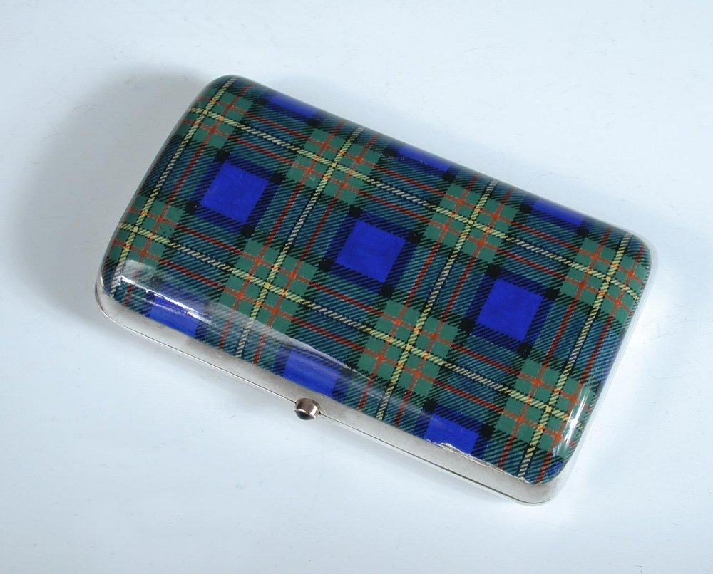 A large Edwardian silver pocket cigar case,: A large Edwardian silver pocket cigar case, by William Frederick Wright (Wright & Davies), London 1906, rectangular with curved section, the cover enamelled with green and blue tartan with yellow and