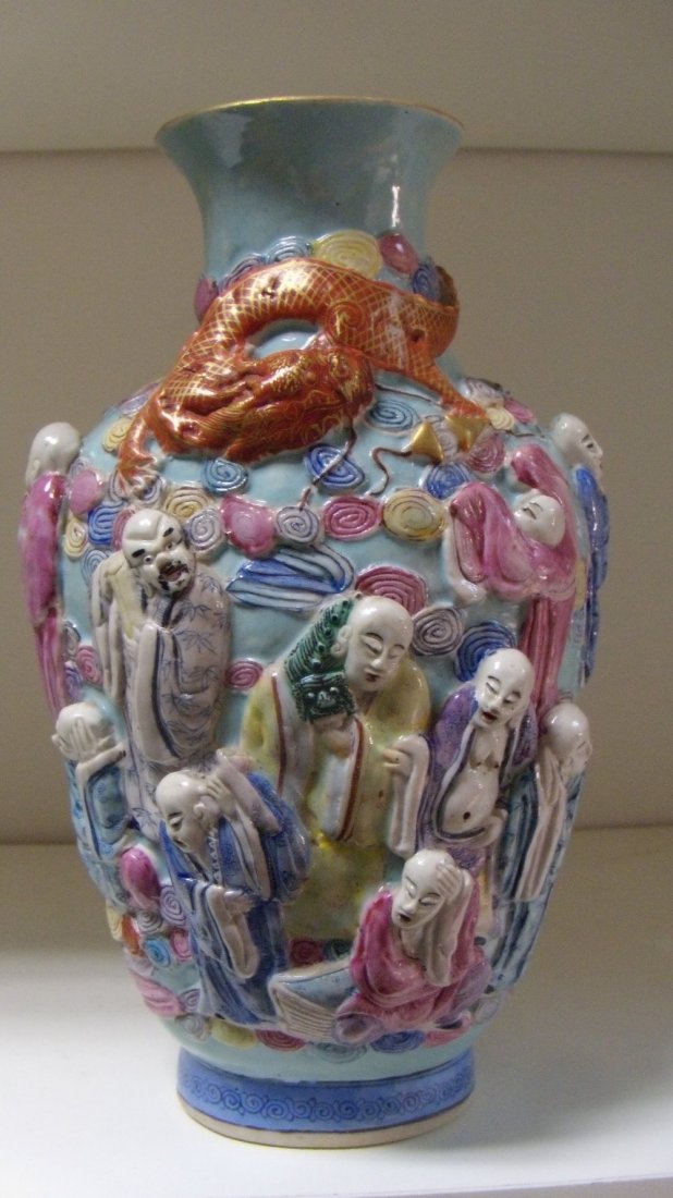 A 19th century turquoise relief moulded vase,: A 19th century turquoise relief moulded vase, depicting a red dragon above immortals in the clouds on a turquoise ground, seal mark of Qianlong, 22cm (8.5 in) high (R)