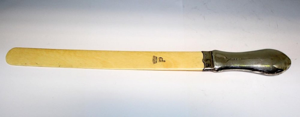 An Edwardian silver handled page turner,: An Edwardian silver handled page turner, by William Harrison Walter, Birmingham 1903, with worked ivory blade, inscribed in black with the letter P (Peel) below a coronet, 35cm long,