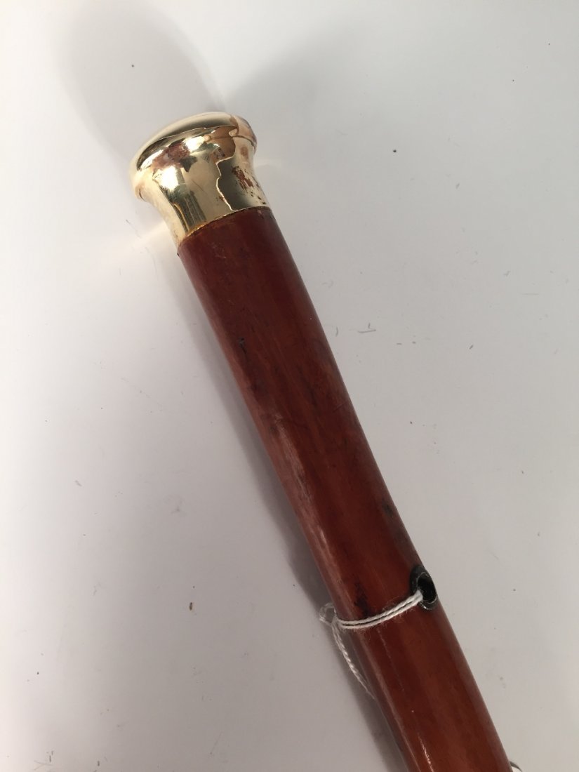 A 19th century mallacca walking cane with precious: A 19th century mallacca walking cane with precious yellow metal mount, tests as 14ct gold, engraved with crest of a unicorn head out of a ducal coronet, possibly that of the Carrington family, althoug