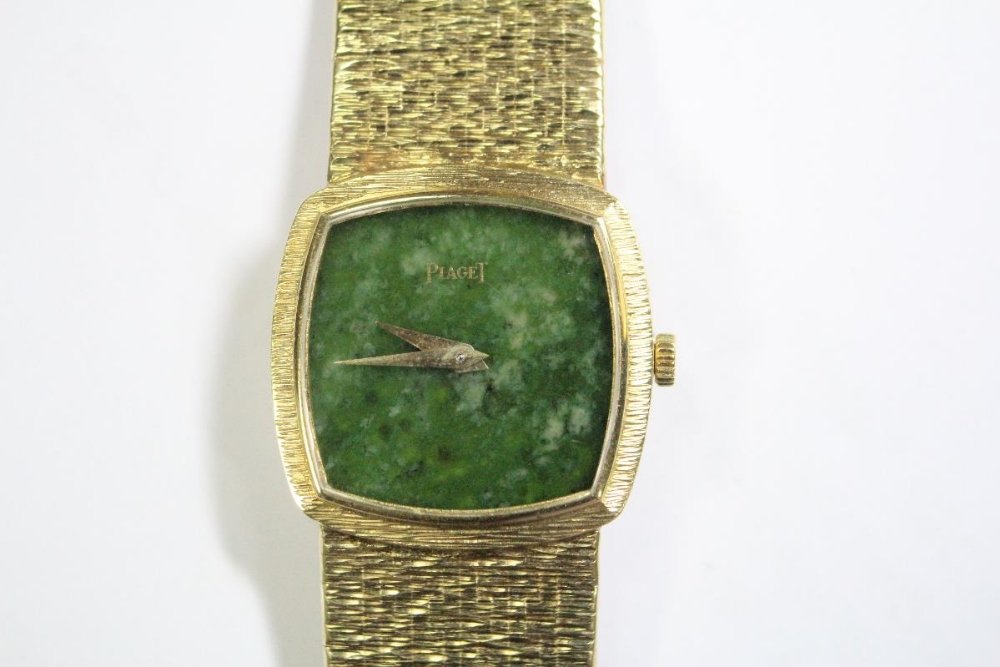 By Piaget - a lady's 18ct gold wristwatch,: By Piaget - a lady's 18ct gold wristwatch, the rounded square dial with textured bezel, nephrite dial without markers, signed Piaget, mechanical movement, to integral textured and tiled articulated br
