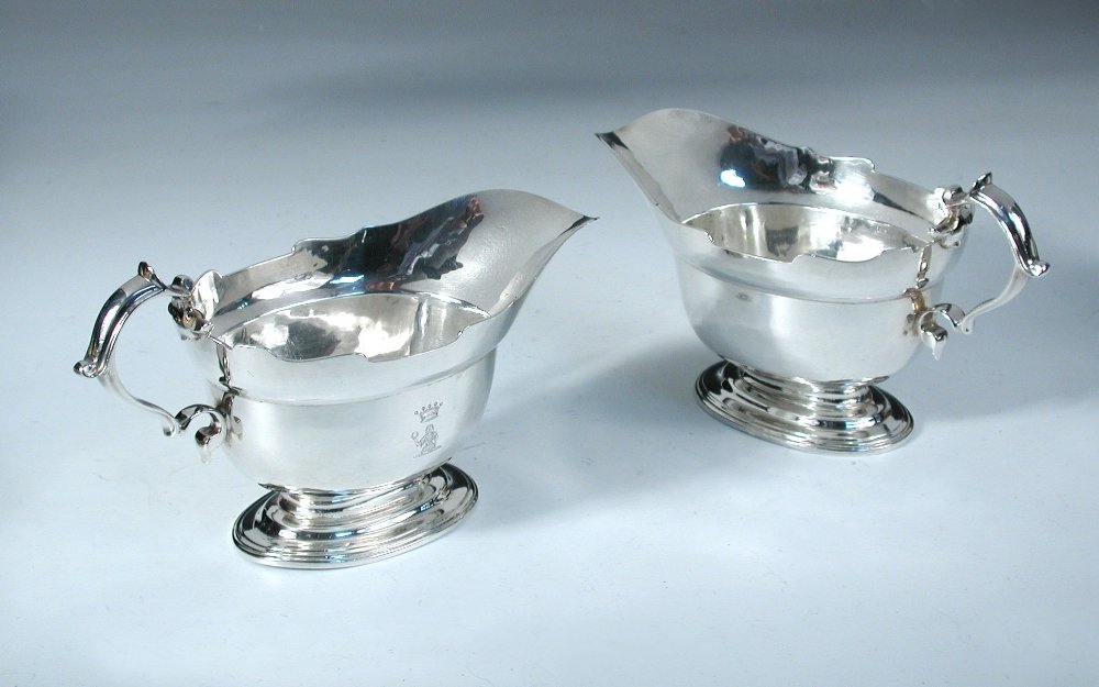 A pair of Britannia standard sauceboats,: A pair of Britannia standard sauceboats, by Richard Comyns, London 1938, each of good gauge, the oval bodies standing on oval stepped pedestal feet, everted rims with cut edges, 'S' scroll handles, cr