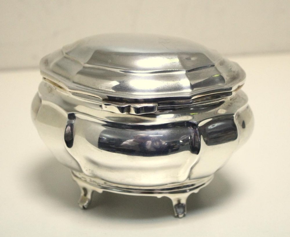 A small Edwardian silver tea caddy,: A small Edwardian silver tea caddy, by Charles Stuart Harris & Sons, London 1909, of lobed bombe shape raised on four short out turned feet, with conforming shallow domed cover, 9cm high, 5.41oz