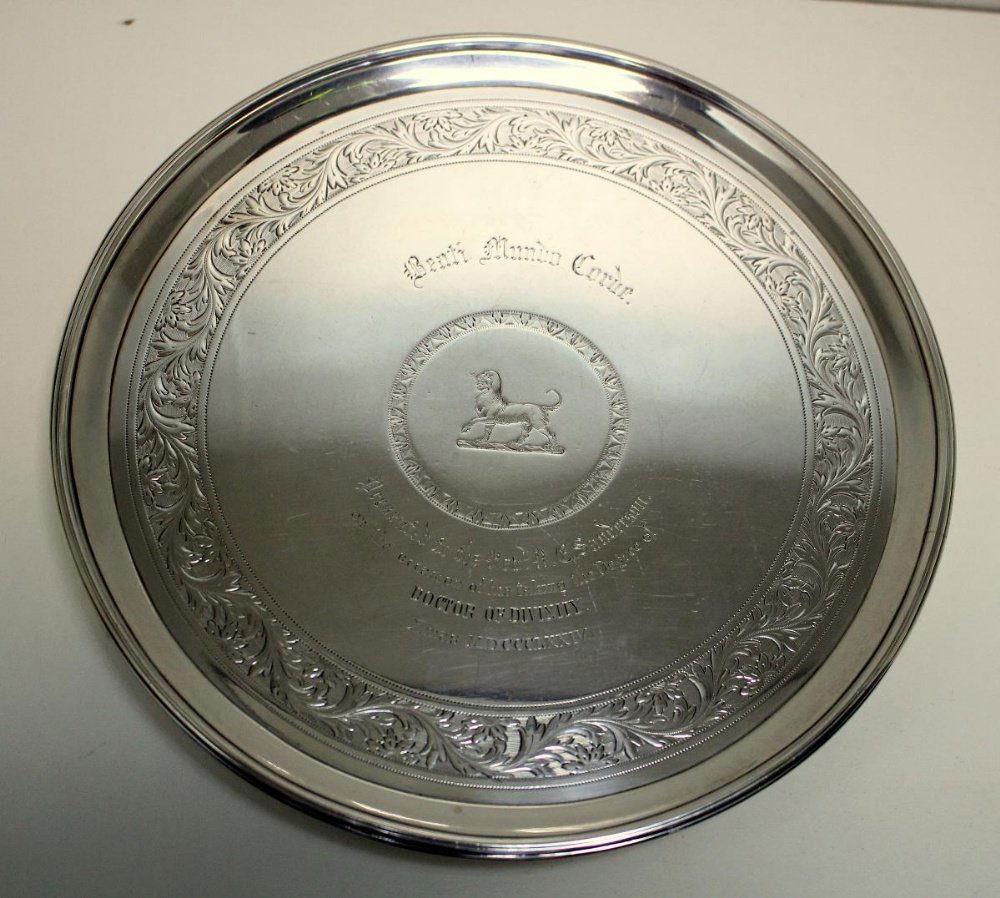 A small George III silver salver,: A small George III silver salver, by Daniel Smith and Robert Sharp, London 1787, circular with moulded reeded edge, raised on three scrolled feet, the ground with engraved foliate border around a cent