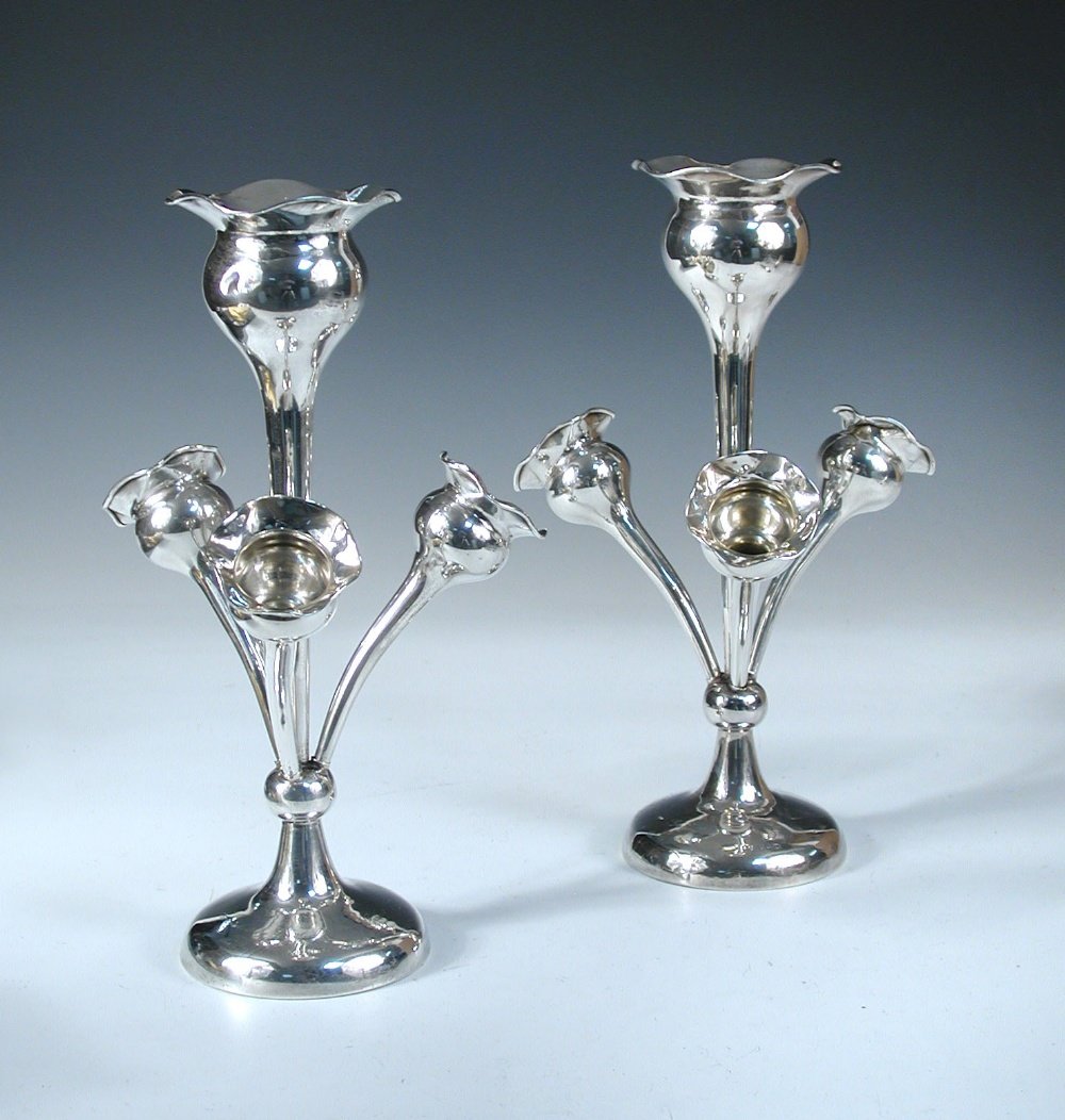 A pair of Edwardian silver epergnes,: A pair of Edwardian silver epergnes, by Joseph Gloster, Birmingham 1907, each raised from a plain circular foot below a tall tapering stem with bulbous flared top, the base of the stem knopped support