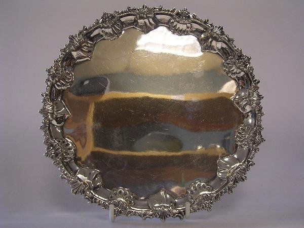A late Victorian silver salver Charles Stuart Harr: A late Victorian silver salver Charles Stuart Harris London 1896 circular with shell gadrooned edge raised on three scrolled feet 20.25cm 11oz