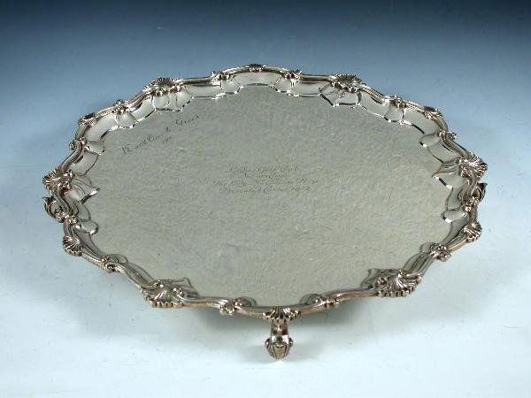 EDWARDIAN SILVER SALVER: An Edwardian silver salver, Charles Stuart Harris, London 1907, circular with shaped shell scrolled edge, raised on four scrolled feet, inscribed "The Lady McCallum Trophy Nuwara Eliya Golf Club", 36c