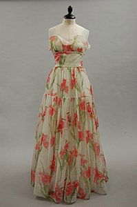 A Murray Arbeid printed chiffon romantic ball gown: A Murray Arbeid printed chiffon romantic ball gown, late 1970s-early 1980s, labelled, printed overall with pink irises, flounced bodice and full skirt, bust 86cm, 34in, waist 72cm, 28in