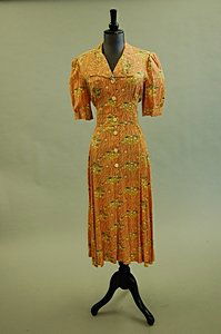 A group of six garments, early 1970s, including, S: A group of six garments, early 1970s, including, Sterling Cooper three piece brown wool trouser suit, a Radley green crêpe midi dress, a Jeff Banks pink floral print dress and others, average bust 92