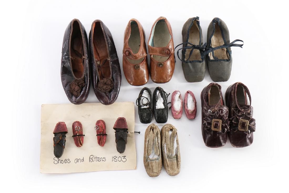 A group of infant and doll shoes, mainly 19th century,: Description: A group of infant and doll shoes, mainly 19th century, nine assorted pairs, including carved wooden pattens, pale-blue baby pumps with note stating they were worn by Mary Hume White at th