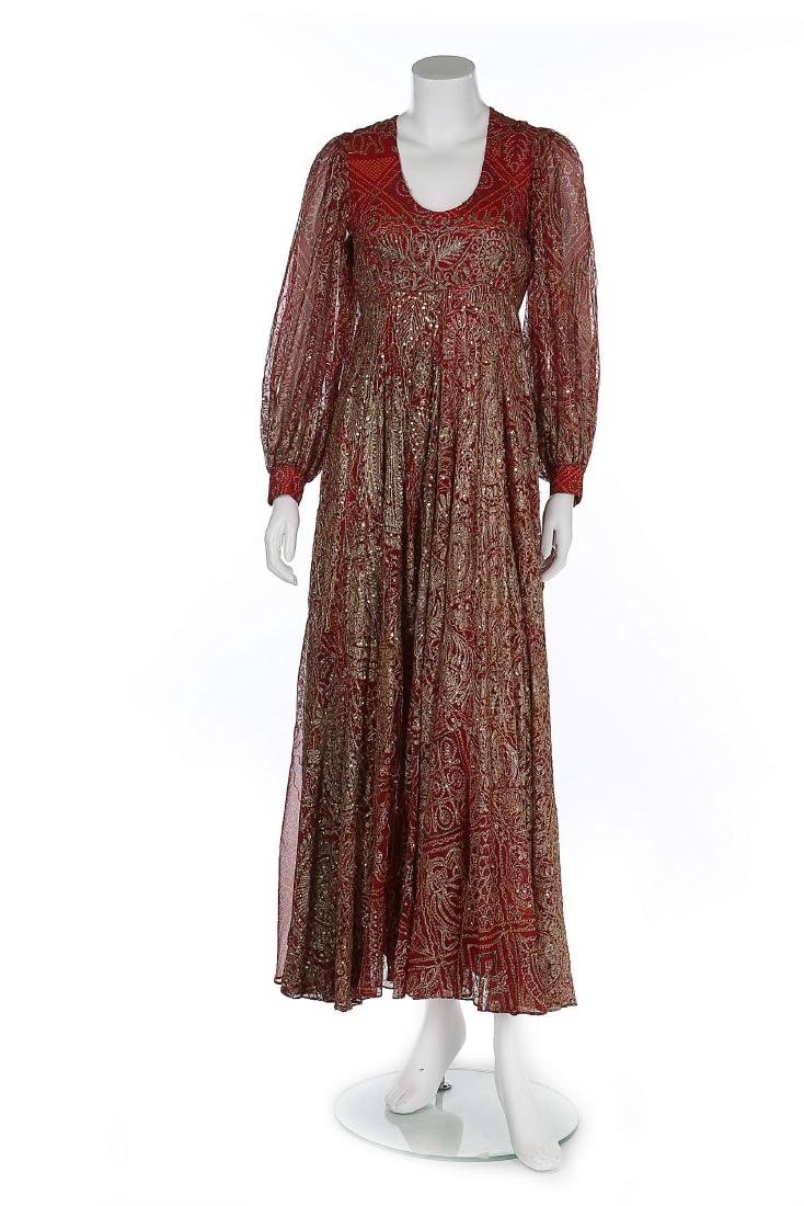 A Thea Porter embroidered and printed chiffon evening: Description: A Thea Porter embroidered and printed chiffon evening gown, 1970s, couture labelled, the Indian silk chiffon printed with elephants and foliate motifs within squares, lavishly over-embroi