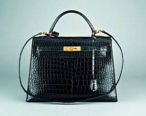 An Hermès black crocodile Kelly bag, French, 1980s,: An Hermès black crocodile Kelly bag, French, 1980s, bearing maker's marks to front closure, with croc covered lock, fob with key, detachable shoulder strap, 33cm, 13in Please note there are export