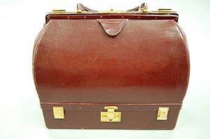 An Hermès burgundy leather Malette, probably 1960s,: An Hermès burgundy leather Malette, probably 1960s, with crimson velvet lined jewel compartment to the base, leather lined main compartment, gilt brass clasps, 32cm, 12 1/2in long