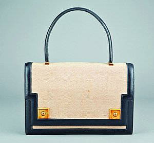 An Hermès canvas and black leather `Piano' handbag,: An Hermès canvas and black leather `Piano' handbag, circa 1960-70, stamped to the interior Hermès, Paris, lined in softest kid leather, twin gilt brass square lifter clasps, 25cm, 9 1/2in