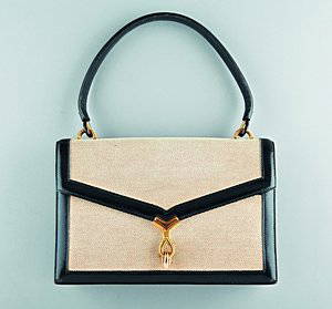 An Hermès tan canvas and black leather handbag, cir: An Hermès tan canvas and black leather handbag, circa 1960-70, stamped to the interior Hermès, Paris, lined in softest kid, gilt brass rope-twisted lifter clasp, 25cm, 9 1/2in