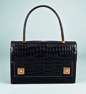 .An Hermès dark brown crocodile `Piano' handbag, c: .An Hermès dark brown crocodile `Piano' handbag, circa 1960, stamped to the interior Hermès, Paris, lined in softest kid leather, twin gilt brass square lifter clasps, 25cm, 9 1/2in Please note