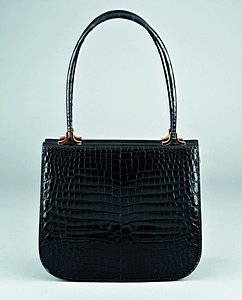 An Asprey black crocodile handbag, circa 1970, stam: An Asprey black crocodile handbag, circa 1970, stamped in gold to the interior Asprey, with hidden 'pull lock mechanism', 24cm, 9 1/2in long Please note there are export restrictions on this lot