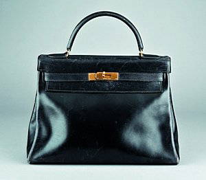 An Hermès `soft' black leather Kelly bag, 1960s, wi: An Hermès `soft' black leather Kelly bag, 1960s, with maker's stamp to the inner front flap and engraved on the closure straps, gilt metal trim, 32cm, 12 1/2in.